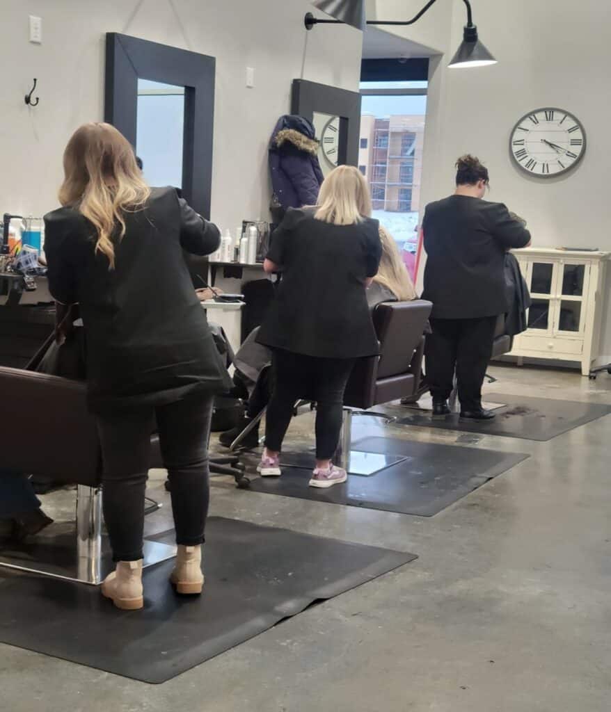 Hairdressers at salon working on clients