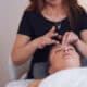 Woman having face massage in salon